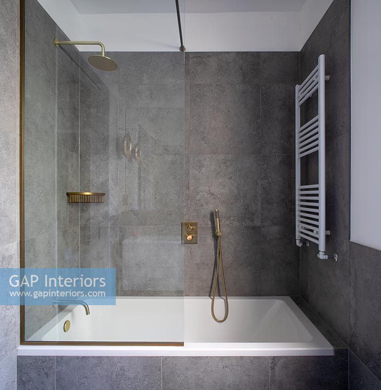 Grey and white modern bathroom with gold taps 