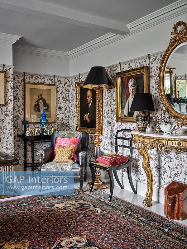 Classic living room  with patterned wallpaper and antique furniture 