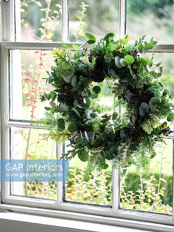 Traditional window with Christmas wreath 