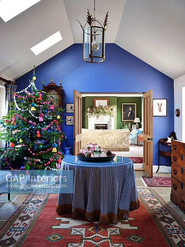 Blue painted hallway with Christmas tree 