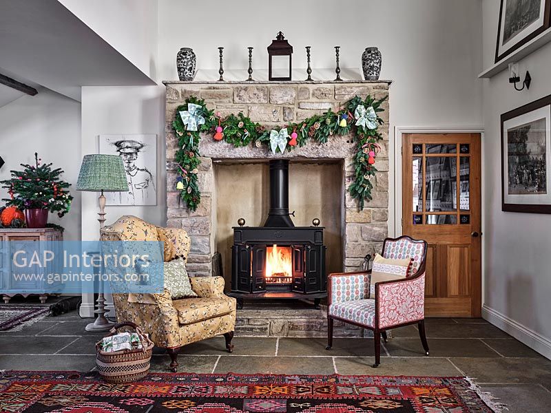 Stone fire surround decorated with a Christmas garland 