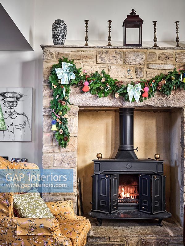 Stone fire surround decorated with a Christmas garland 
