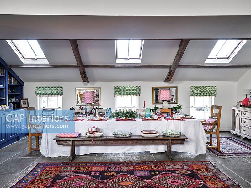 Long dining table decorated for Christmas in country dining room 