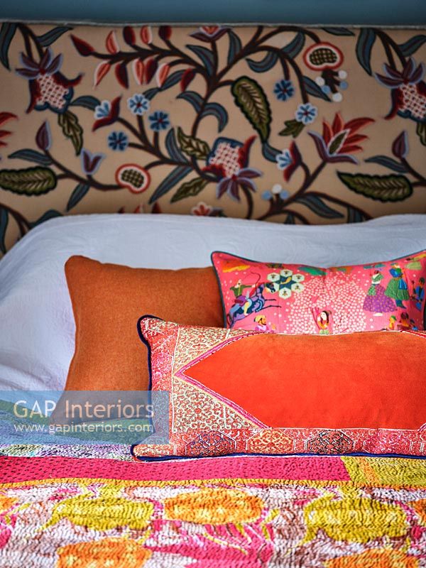 Colourful cushions on bed