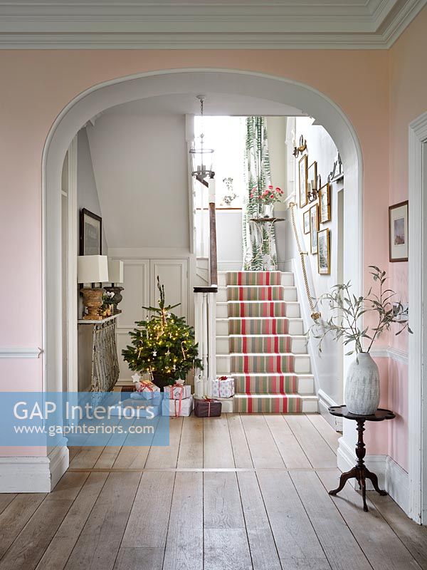 View through archway to hallway decorated for Christmas 