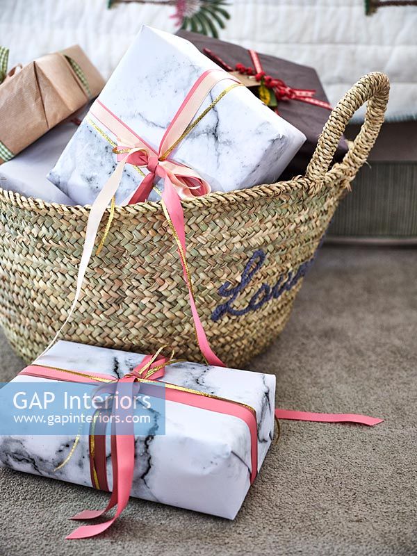 Basket of wrapped Christmas gifts 