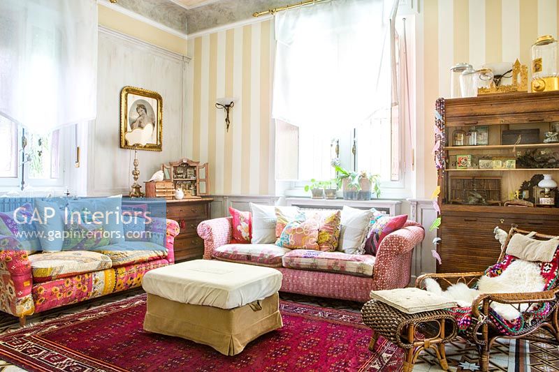 Country living room with patchwork patterned sofas 
