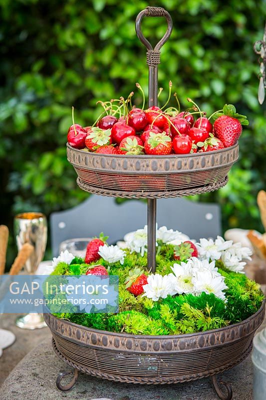 Outdoor dining table detail - centrepiece display with flowers and fruit