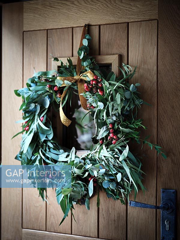 Christmas wreath on wooden door 