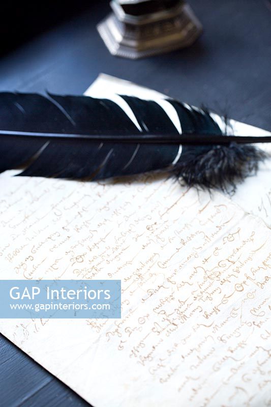 Feather quill and writing paper 