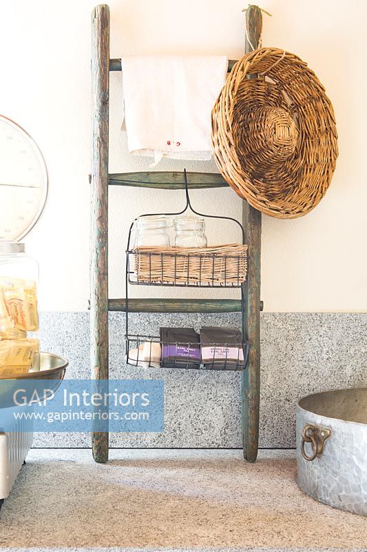 Small piece of wooden ladder repurposed for kitchen storage