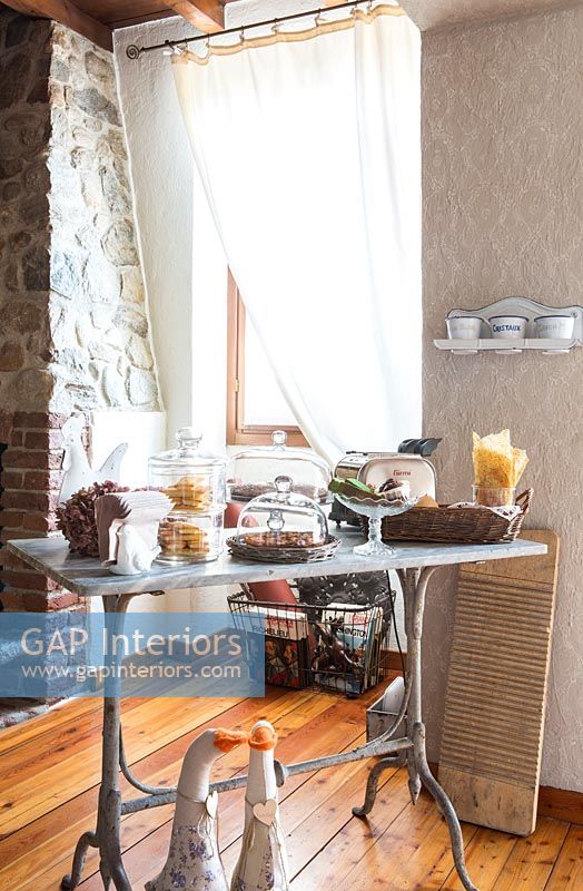 Vintage table with cakes and accessories in country dining room 