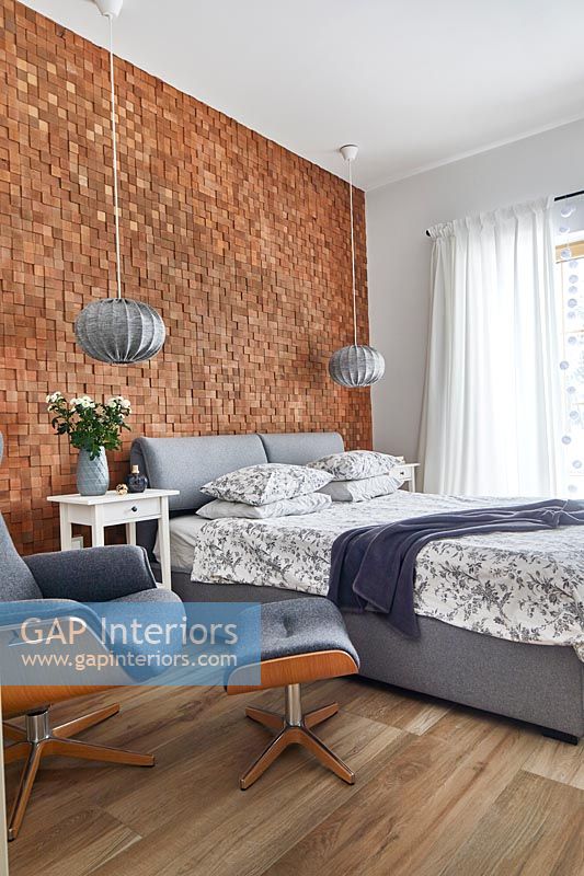 Modern bedroom with textured exposed brick wall 