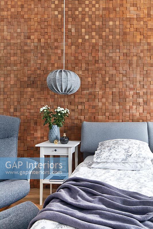 Modern bedroom with textured exposed mosaic brick wall 