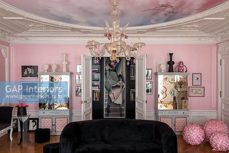 Bright pink eclectic living room with period details 