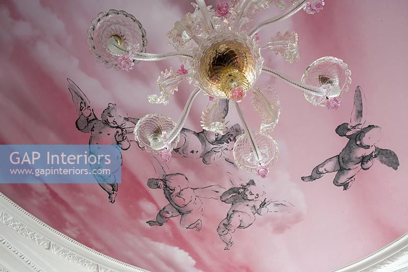 Pink painted mural on ceiling with chandelier detail 