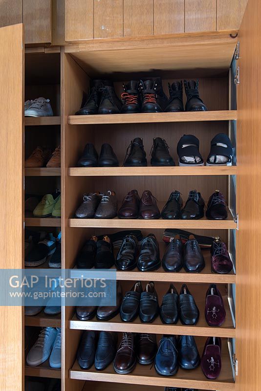 Large shoe racks inside built-in wardrobes 
