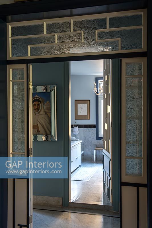 View through Art Deco style interior doors to bathroom beyond 