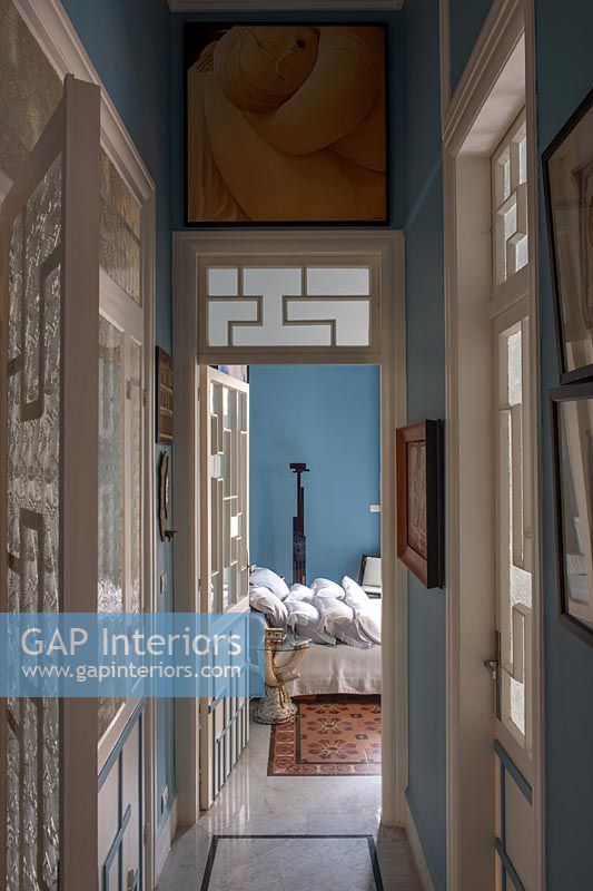 View through Art Deco style interior doors to bedroom beyond 