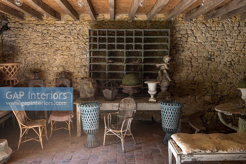 Rustic covered seating area with wicker chairs 