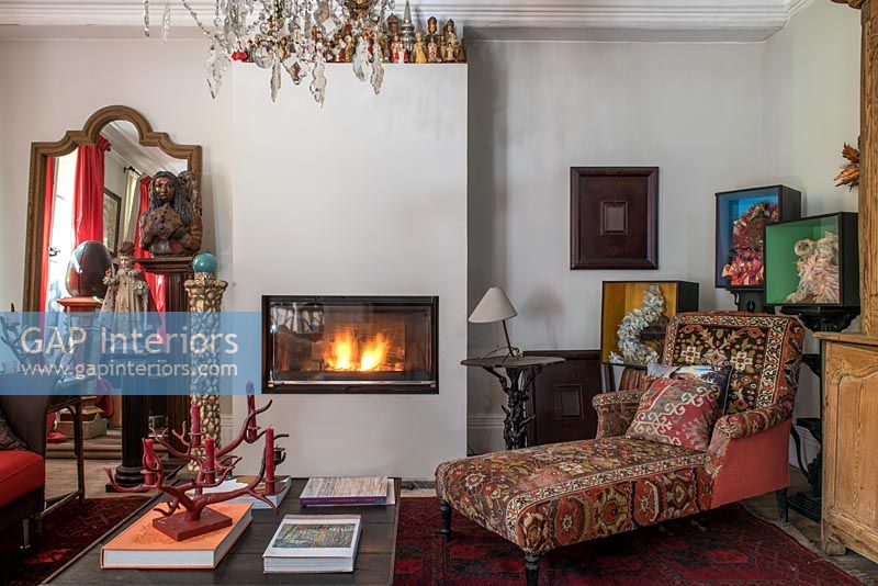 Lit fireplace in eclectic living room 