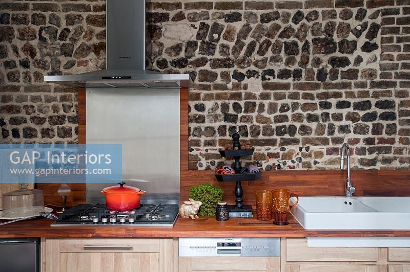 Exposed stone wall in modern country kitchen 