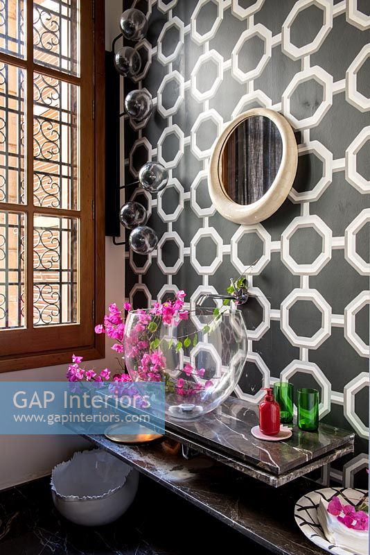 Black and white retro patterned wallpaper in modern bathroom 