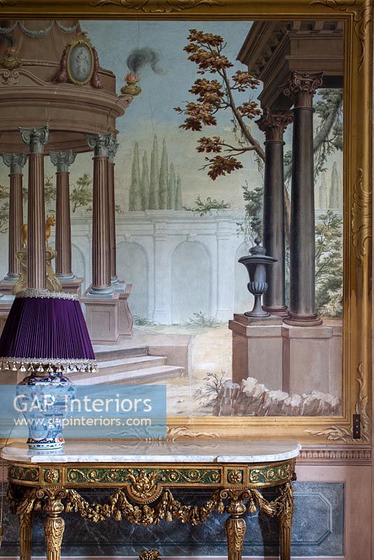 Ornate console table and large classic painting 