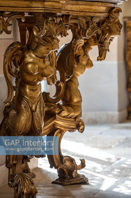 Detail of ornate gilded table legs 