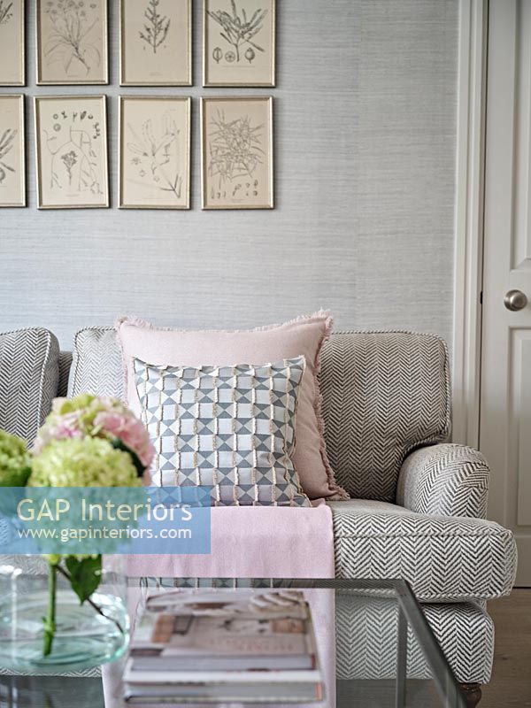 Pink and grey cushions on sofa in modern living room 