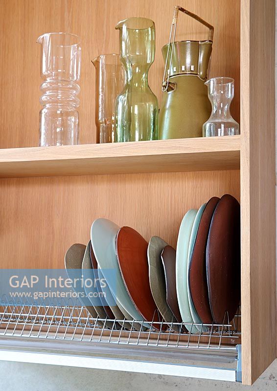 Plate storage rack on shelf with glassware 