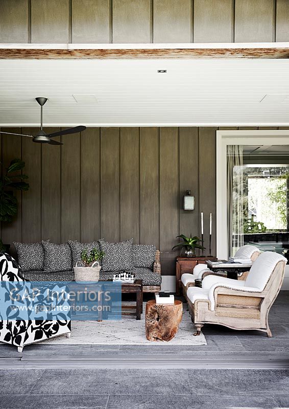 Modern country outdoor living room with eclectic furniture 