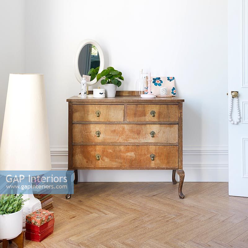 Wooden chest of drawers in bedroom 