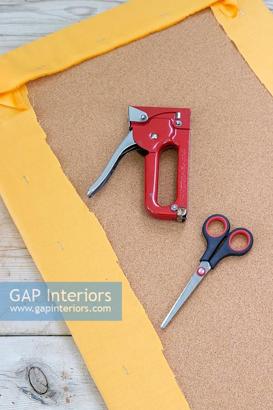 Tools and equipment for stapling fabric to cork board 