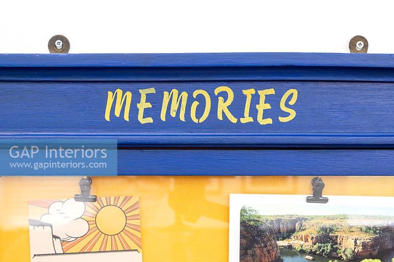 Yellow lettering - Memories - on frame of notice board 