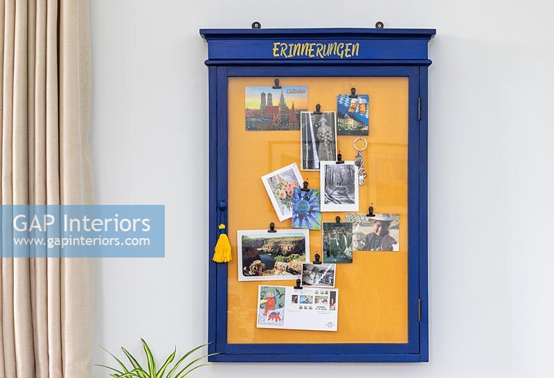 Blue and yellow notice board on wall of modern living room 