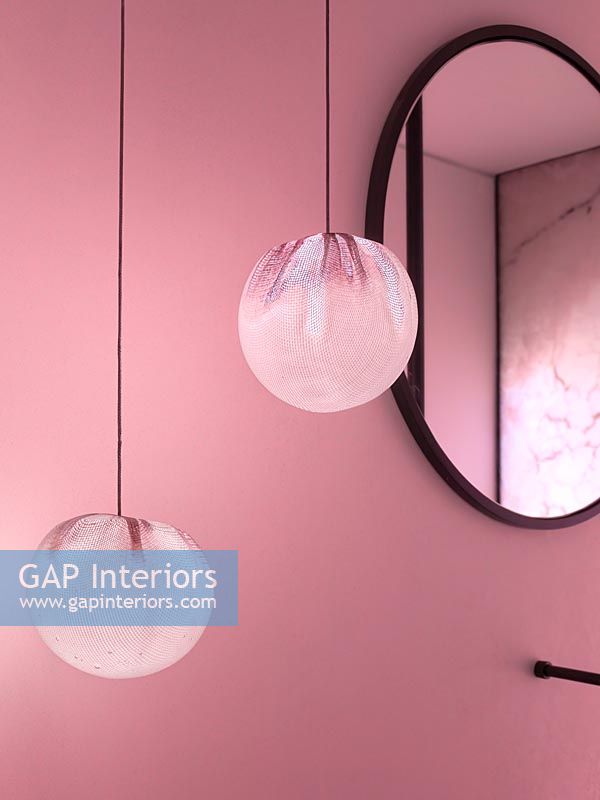 Decorative pendant lights in modern pink bathroom 