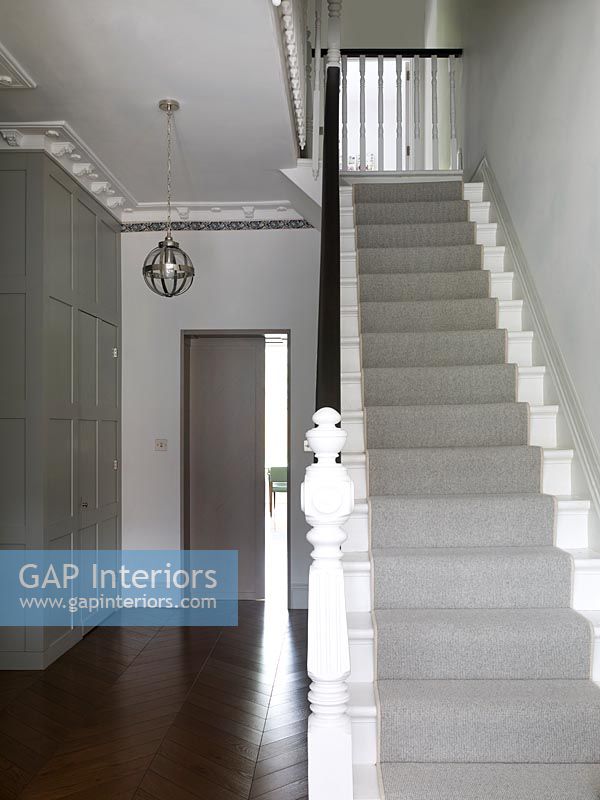 Classic style modern hallway with grey stair carpet 