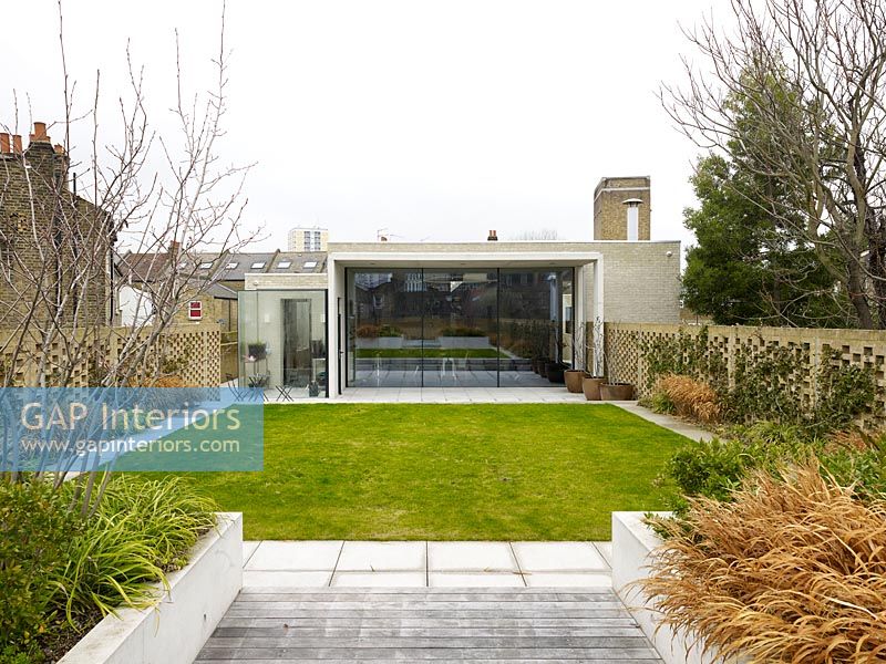 View across garden to contemporary house exterior 