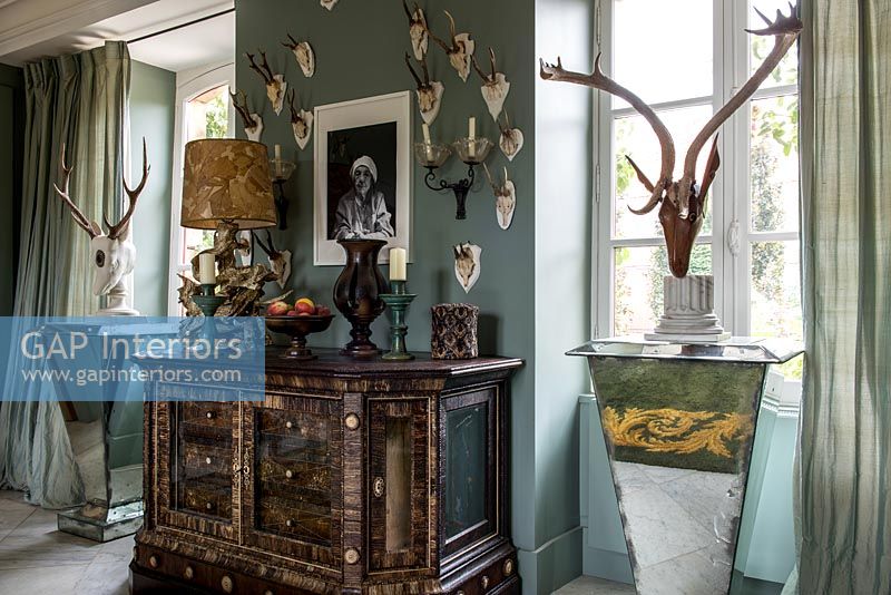 Ornate sideboard and hunting trophy wall display