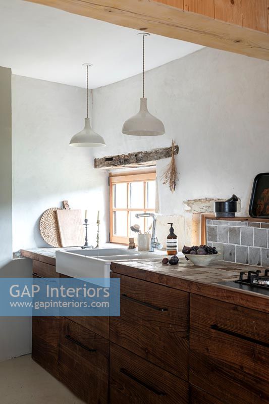 Butler sink set in wooden worktop of modern country kitchen 
