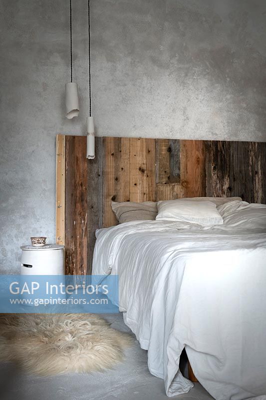 Modern country bedroom with rustic wooden headboard 