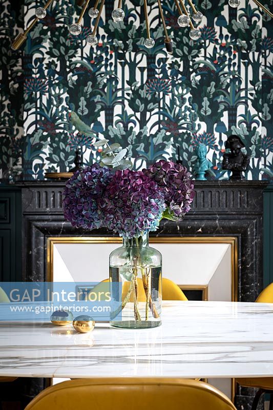 Flowers on table in colourful dining room 