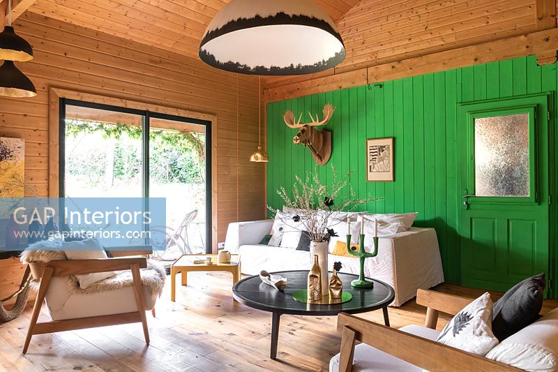 Green painted feature wall in modern country living room 
