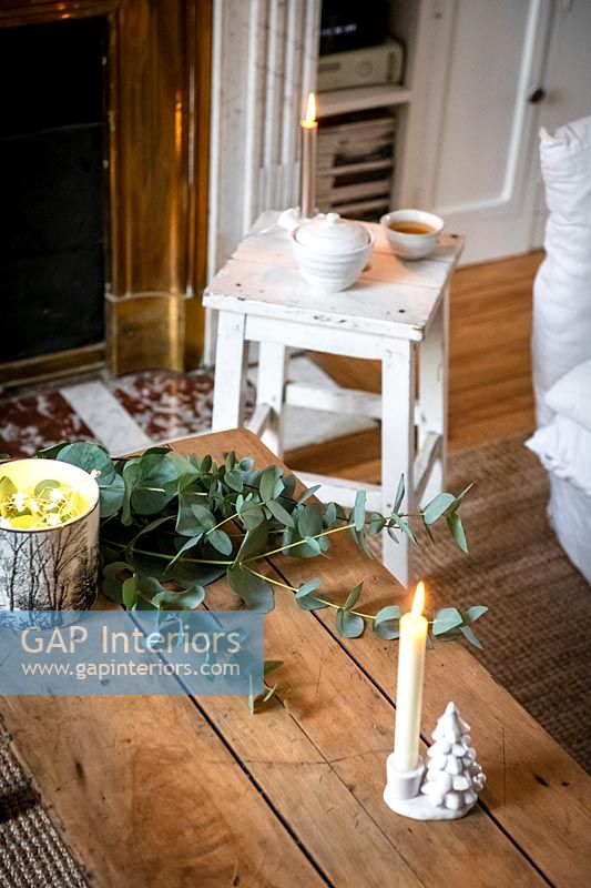 Simple decorations and white Christmas candlestick on coffee table - detail