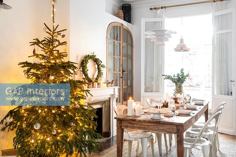 White dining room decorated for Christmas 
