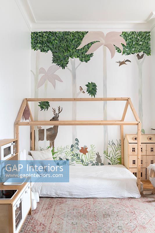 Modern childrens room with timber frame bed