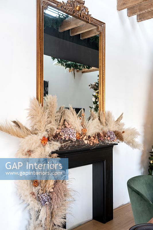 Natural Christmas garland around mantelpiece 