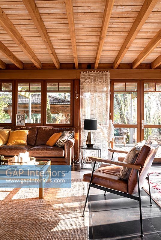 Country living room with sunshine pouring through windows 
