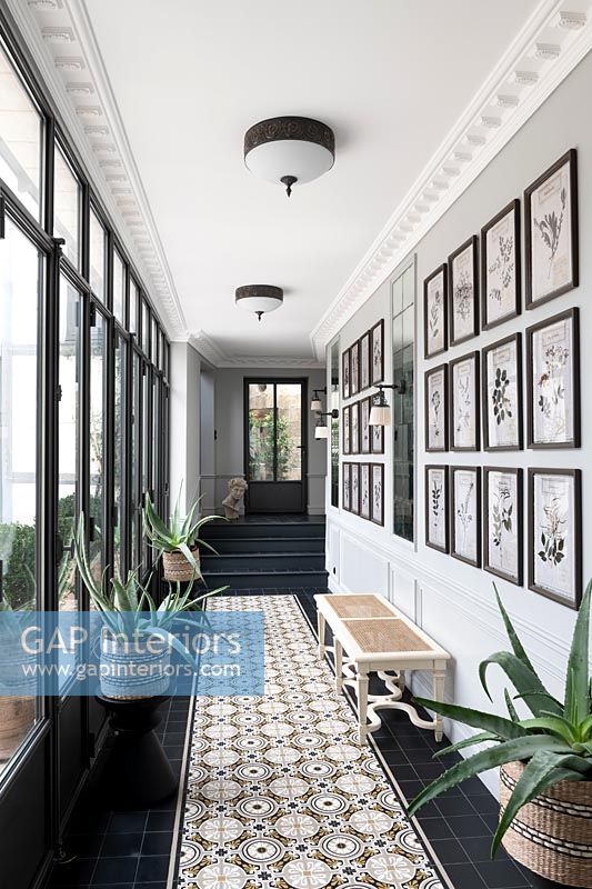 Black and white hallway with patterned tiled flooring 